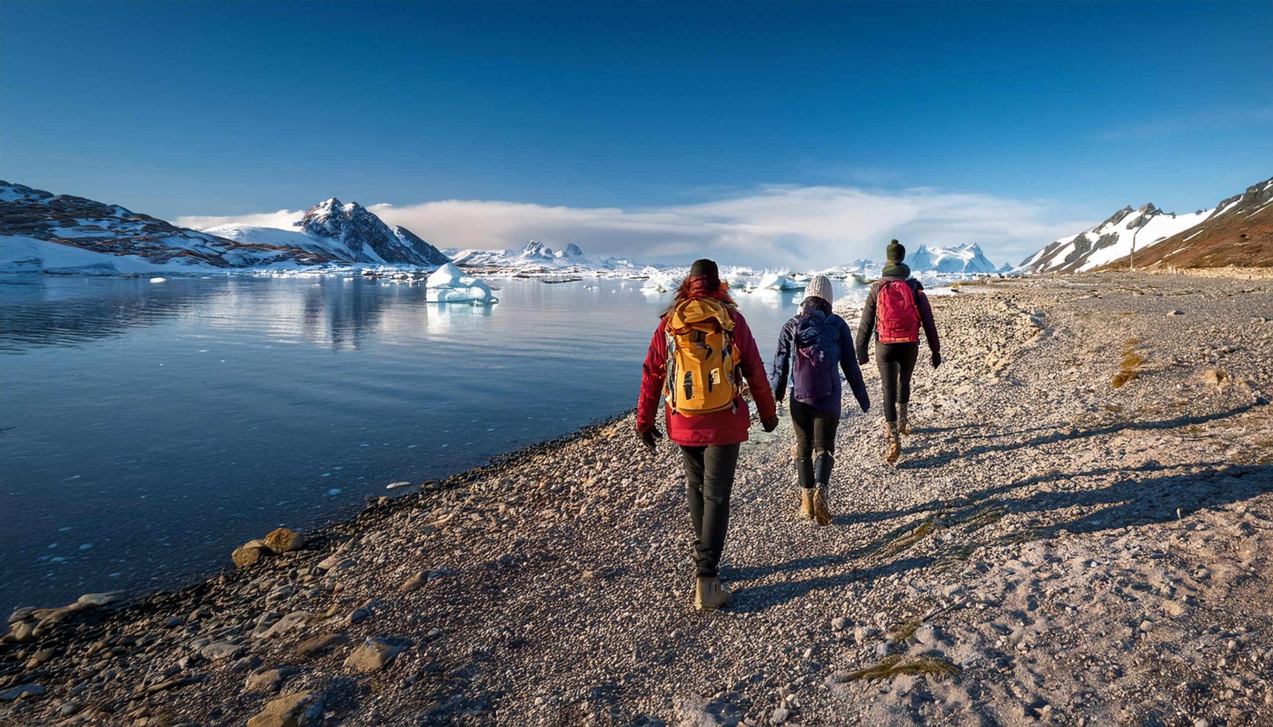 Hikers walking on a remote northern shoreline